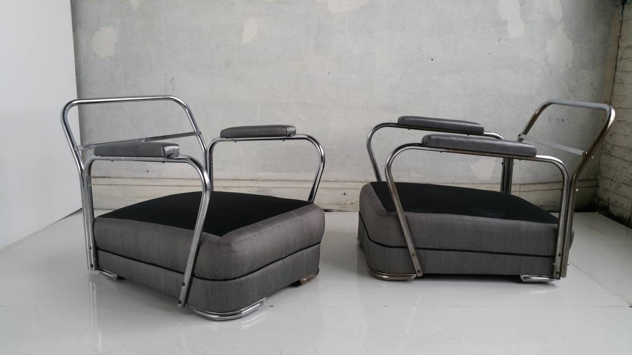 Stunning Pair of Streamline,Art Deco Lounge chairs,,upholstered in silver/grey silk fabric,reversible seat and back cusions in paisley fabric .Unusual chromed steel base,,Extremely comfrotable.