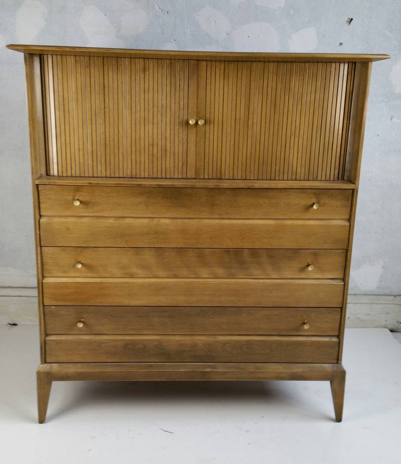 Handsome Tambor Door Chest, Solid Birch.. Quality construction.Modernist brass and enamel pulls,,Slightly curved and beveled top,, Very unusual design,Produced for only one year in limited number for Heywood Wakefield