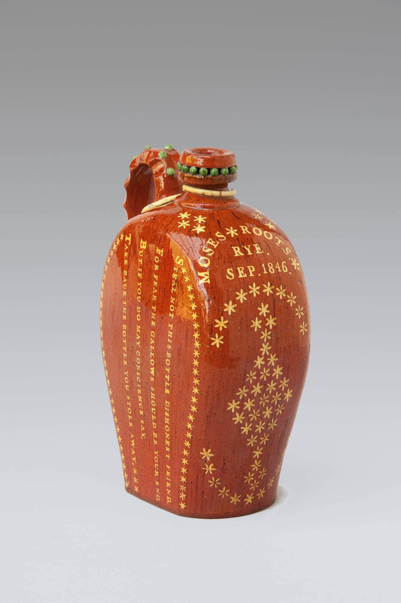 Folk Art harvest flagons such as this were filled with beer or cider to quench the thirst of workers in the fields. The dedicatee of this antique slipware flagon was known to have been an agricultural worker. Though surely as this particular example