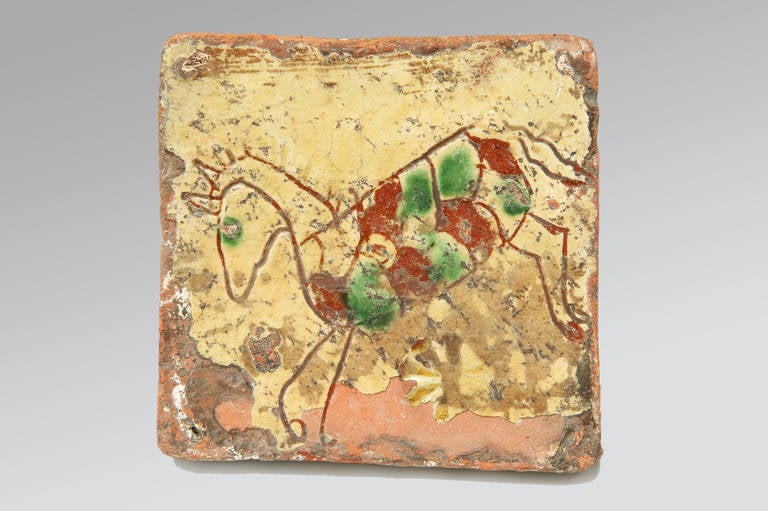 A delightful naively decorated late medieval tile incised with the image of a horse and enriched with colored glazes. From Northern Europe (Possibly Germany or Northern France).