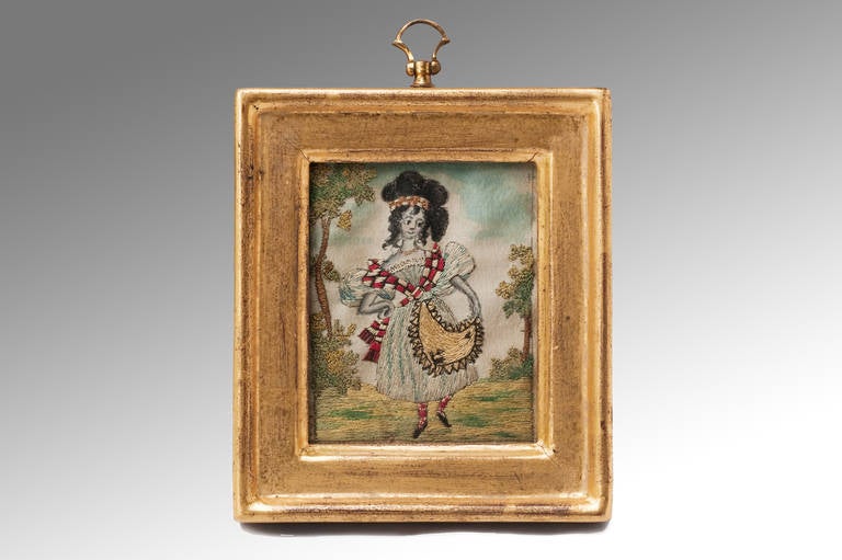 A miniature embroidery the frame measuring only four by four and a Half Inches and encasing a highland lass in national costume performing a jig or Scottish country dance.
