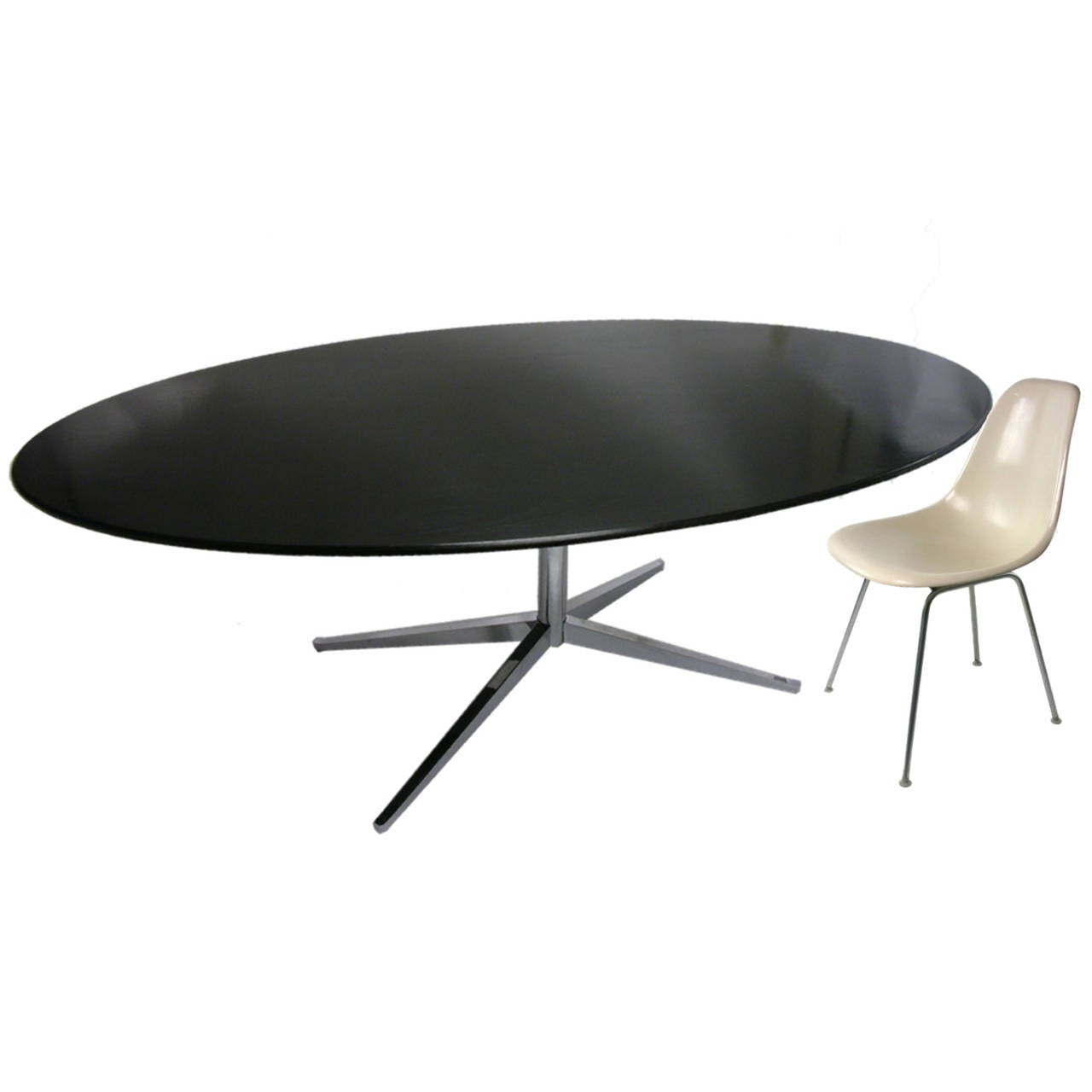 Florence Knoll for Knoll oval dining table. Ebonized oak top with beveled sides. Base is chromed steel. Very heavy and sturdy table. Some scratches on table top.