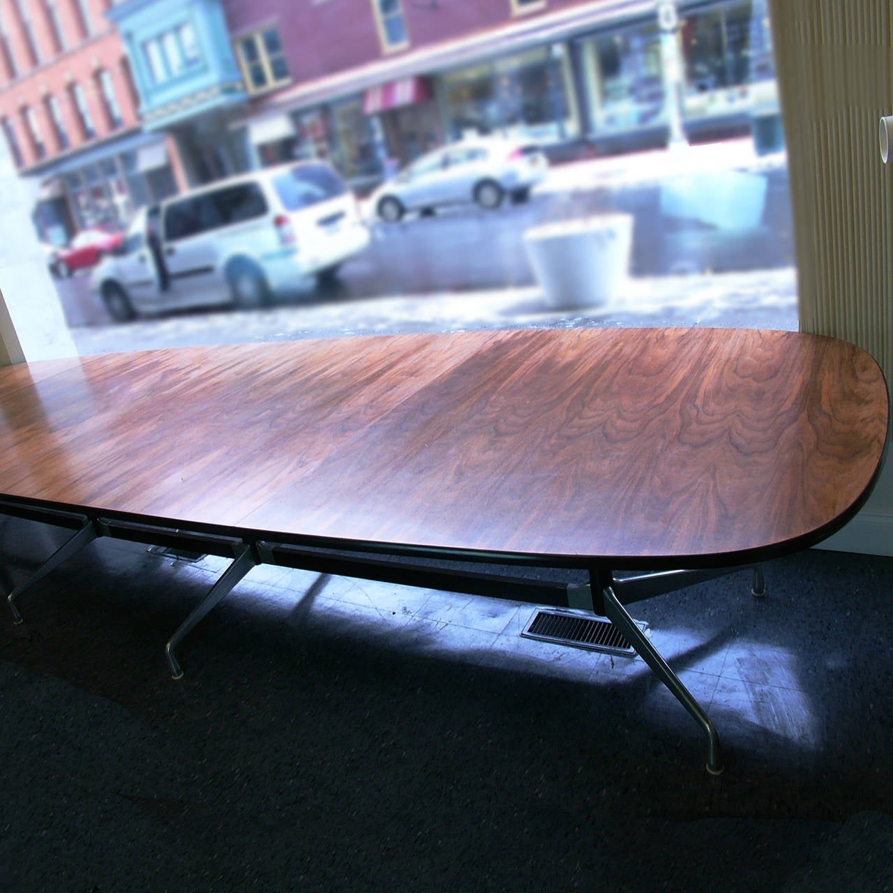 A monumental highly figured walnut Eames segmented base table. The walnut top has beautiful action. Measures: 15 ft.