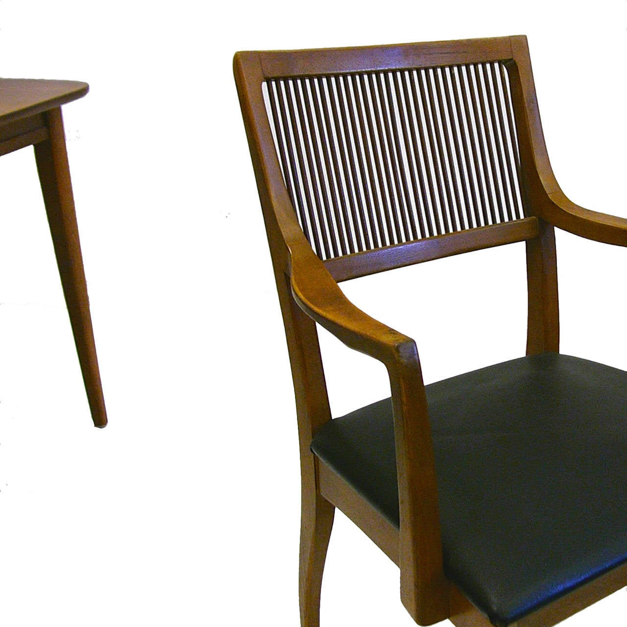 Walnut stained ash dining chairs designed by John Van Koert. Black Naugahyde seats. Set includes six side chairs, and two arm chairs. All pieces are in good original condition.
Arm chairs measure: 21.5