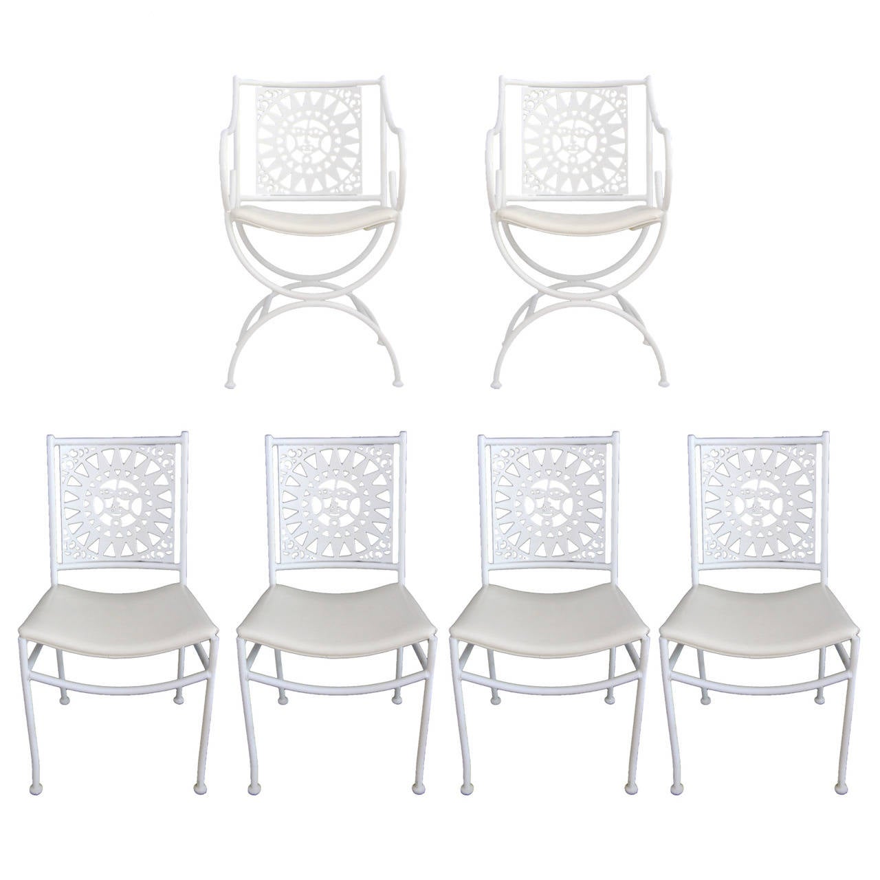 Unique white painted wrought iron table with whimsical sun cut-outs. 
Table measures: 66