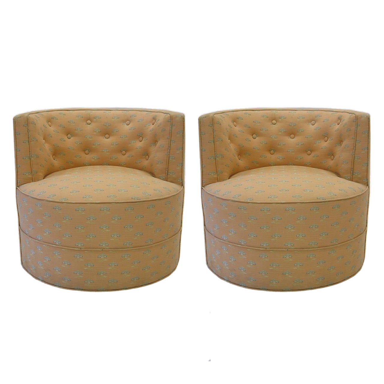 Pair of tufted upholstered tub chairs on wheels.