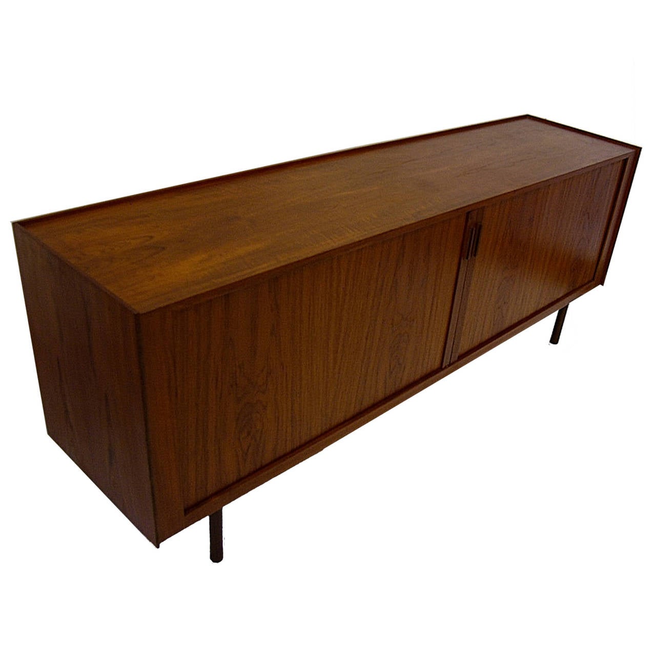 Long and stunning teak Danish credenza. Beautiful subtle tambour doors open to reveal a lovely and functional interior.