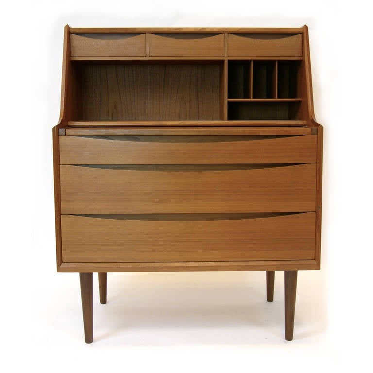Very unique piece by Arne Vodder. This piece can be used as a desk or a vanity. The top drawer opens to reveal a hidden mirror along with a drawer with multiple compartments.