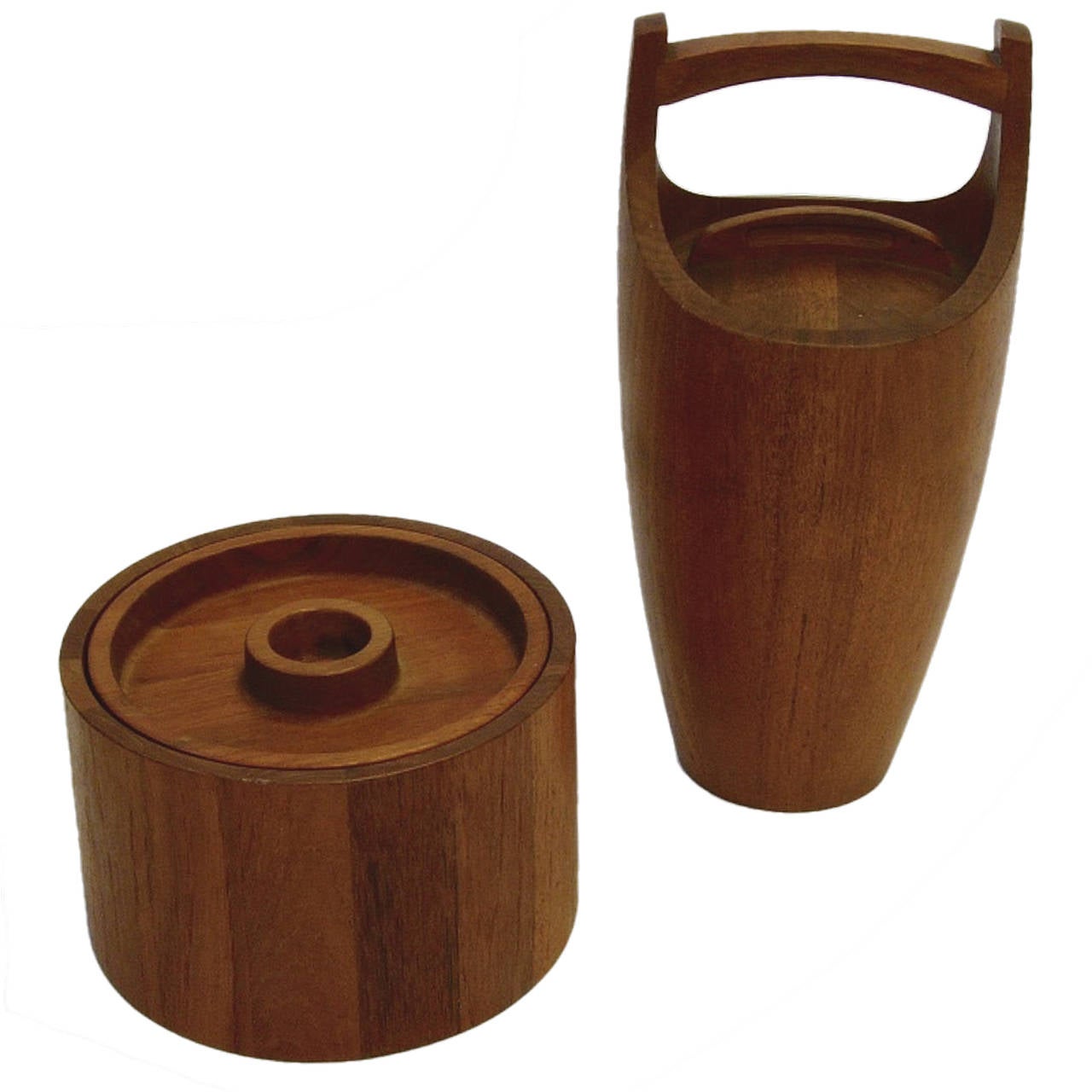 Pair of lined teak ice buckets made by Dansk and designed by Jens Quistgaard. 
Tall  measures:  15.25"tall  x 7" round
Shorter measures:  6" tall  x  9" round