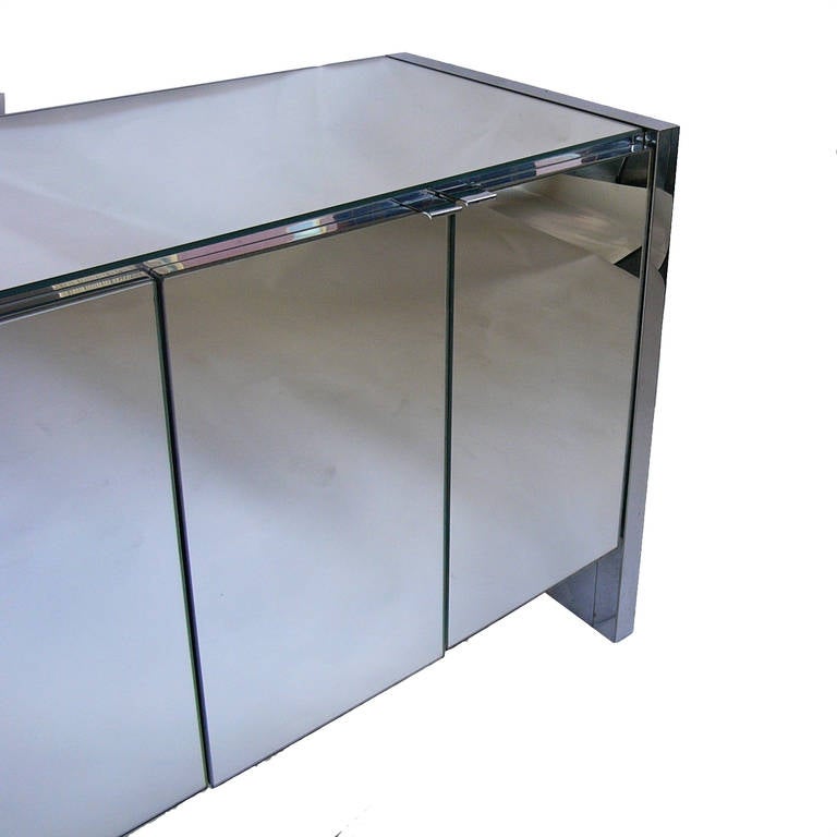 An elegant six door mirrored credenza by Ello, with white interior. Six adjustable shelves inside.

