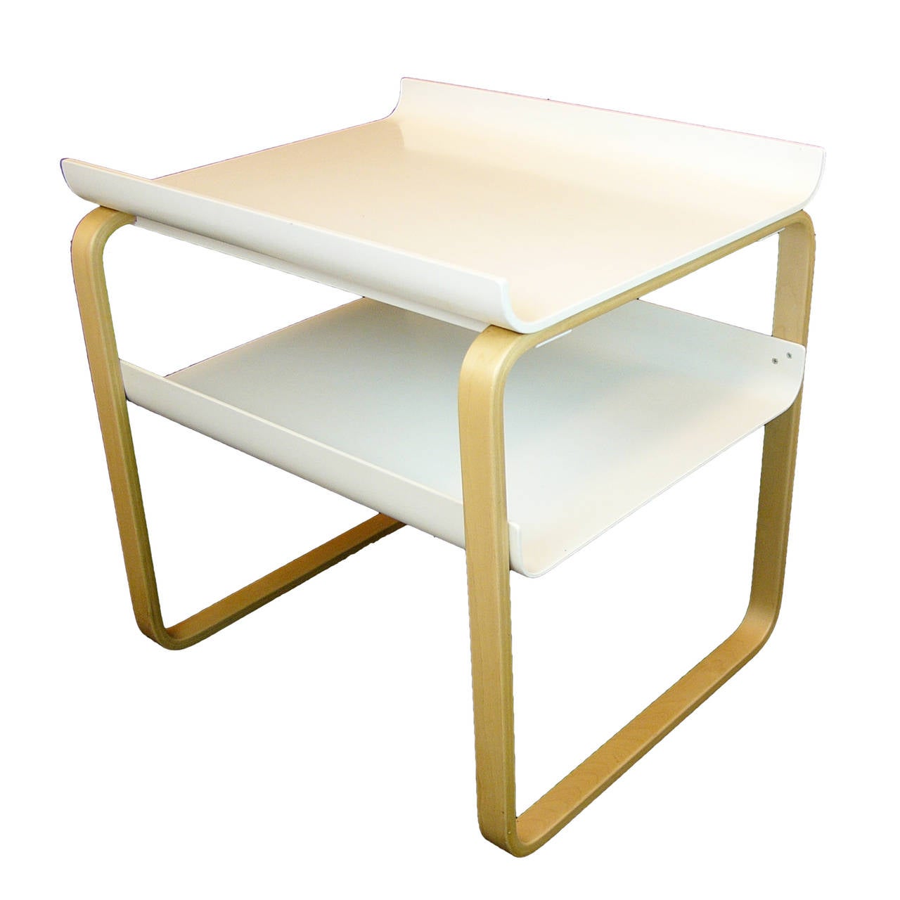 Natural birch side table. Laminated bent birch legs. The top and bottom shelf are made from molded plywood with slightly turned up edges. Designed by Aalto in 1932, this design was original created for the Paimio Sanatorium but was later added to