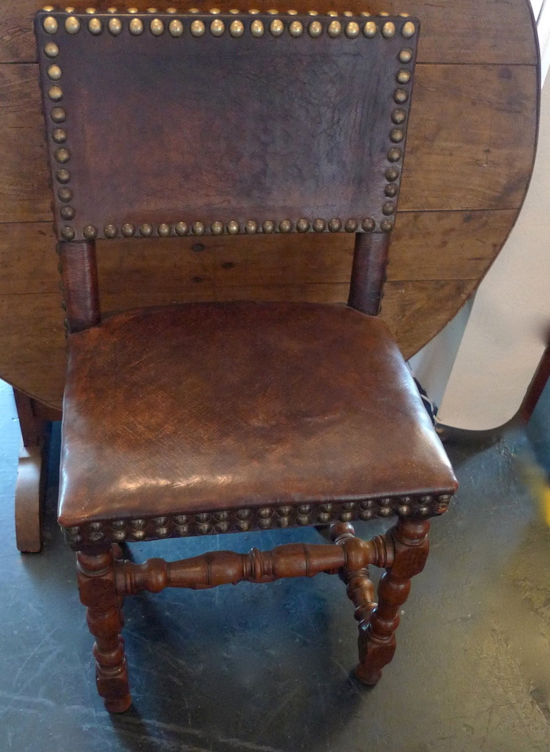 2 Spanish xviii side chairs with studded leather seat & back.