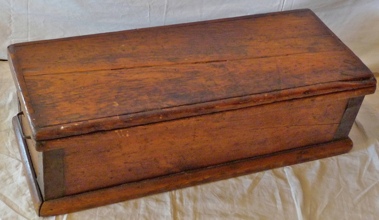 English 19th century fruit-wood storage trunk with iron end handles.