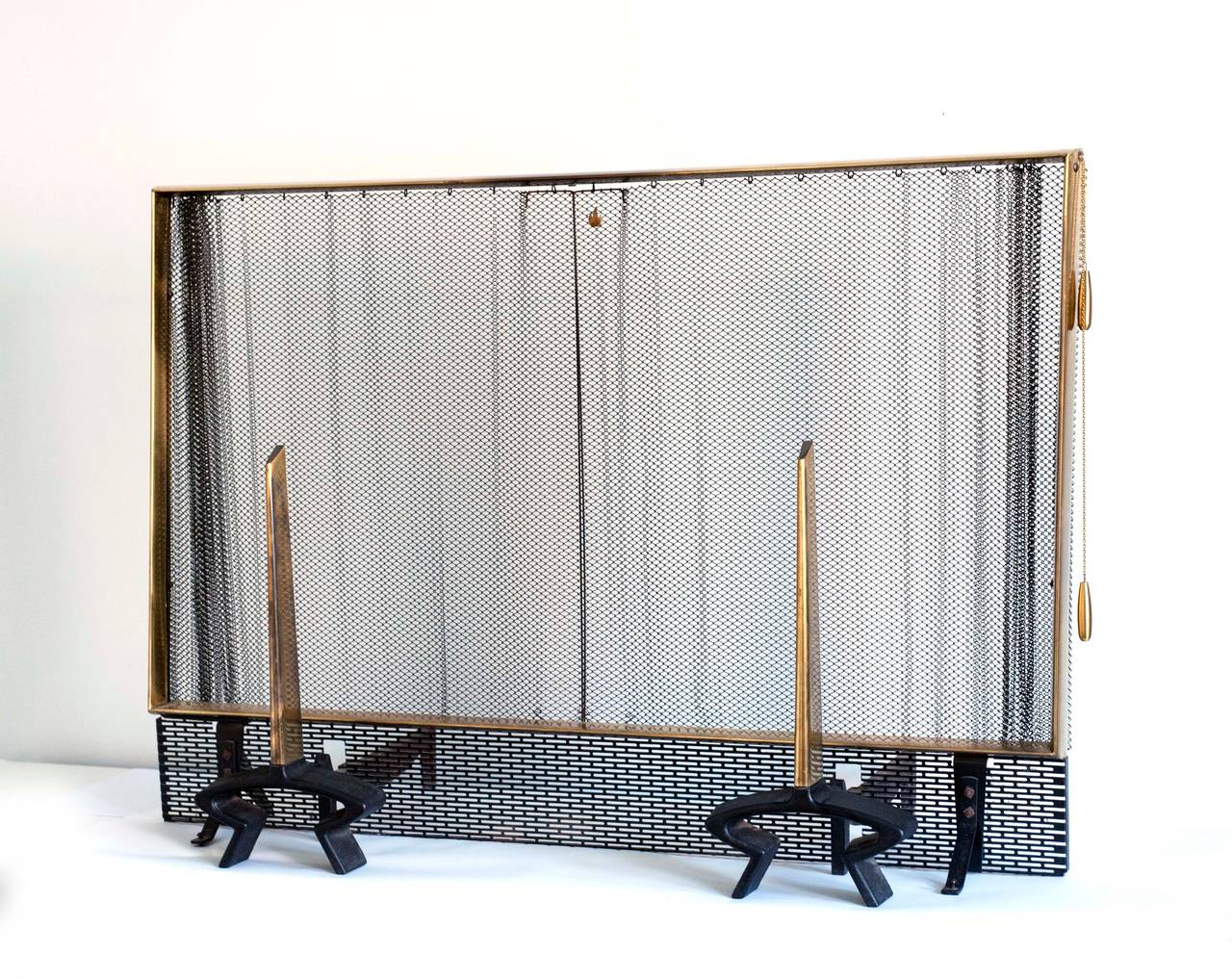 An exceptional modern screen and set of andirons by Donald Deskey for Bennett.  Condition is excellent with no signs of wear except typical patina on brass. Please inquire about set of tools available.  Screen measures 41