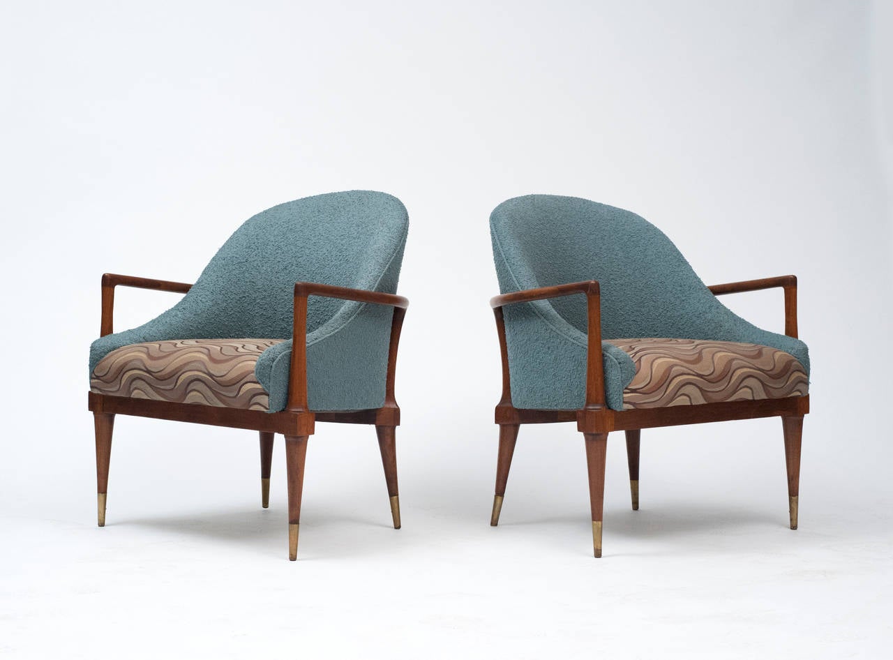 Fantastic unique looking pair of Mid-Century Modern chairs in vintage upholstery. Chairs look great from any direction. Chairs are quality built with solid walnut frame and inner sprung cushions.