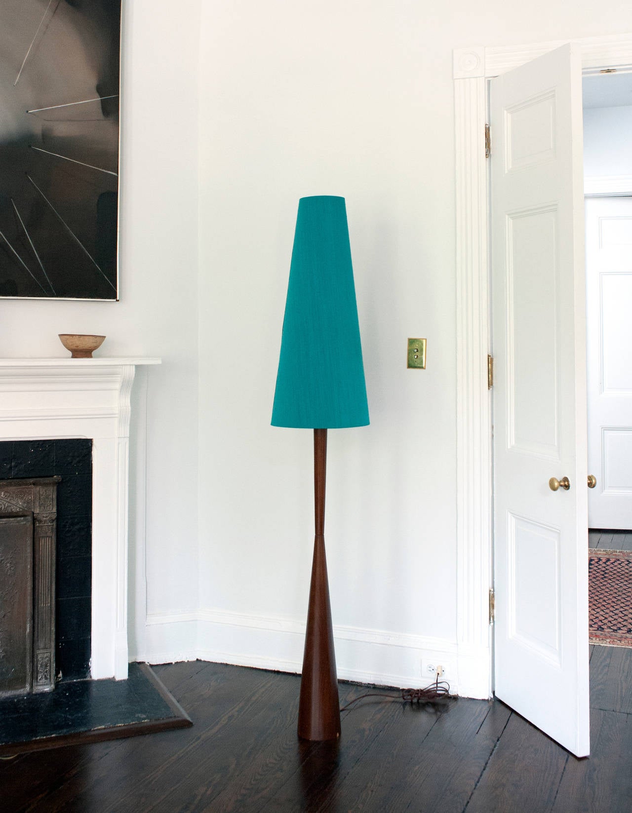 Tall unique Danish floor lamp. Lamp has attractive dark teak base and retains original silk shade.  Lamp produces a very pleasant light. Condition is excellent.