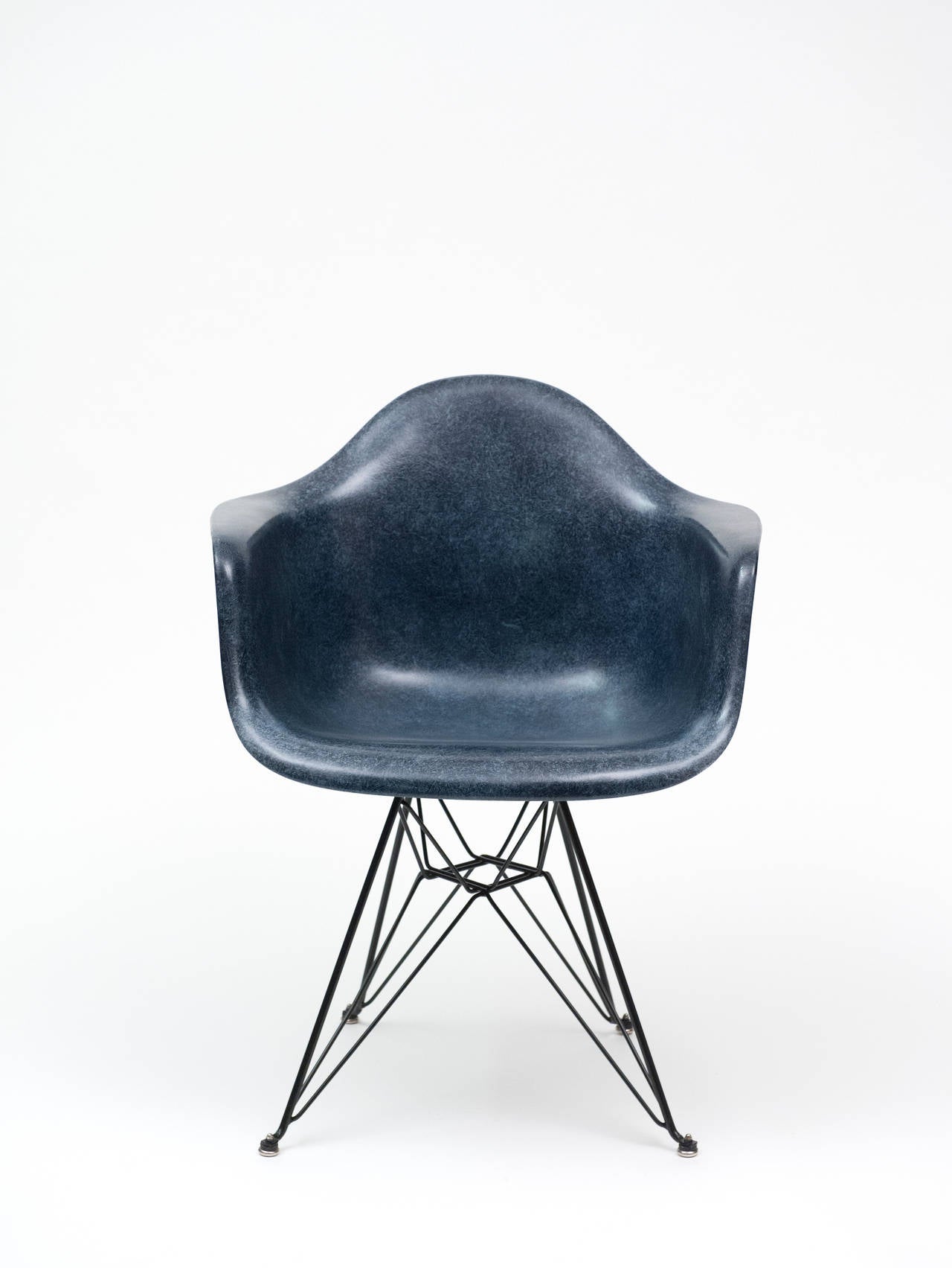 Vintage Herman Miller shell chair designed by Charles & Ray Eames.  Chair is Navy Blue and in excellent condition.   Partial Herman Miller paper label remains.  Two shock mounts have been re-glued.  Base is not original to the chair.