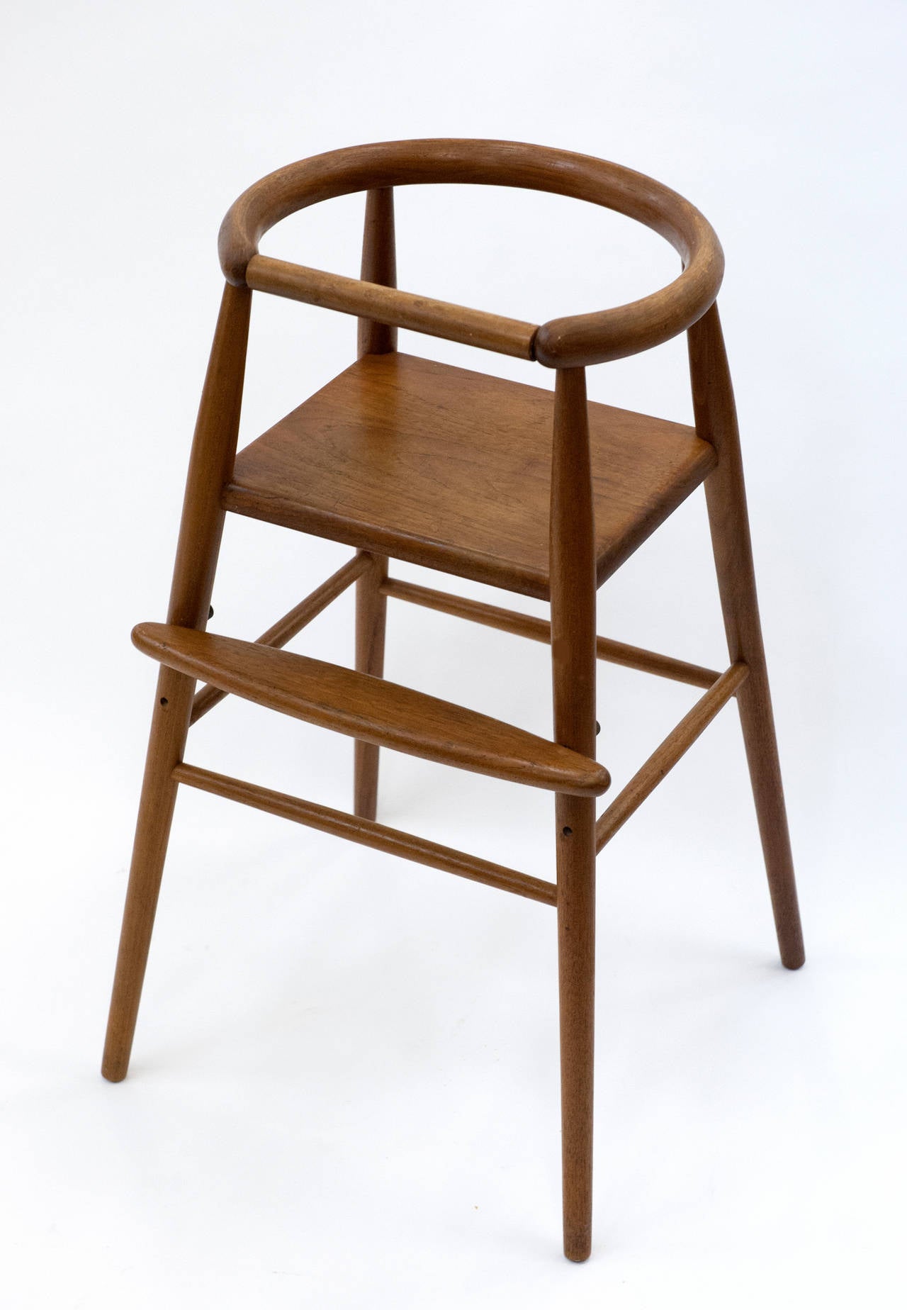 Beautifully designed and constructed high chair by Nanna Ditzel.  Made from solid teak with adjustable foot rest.