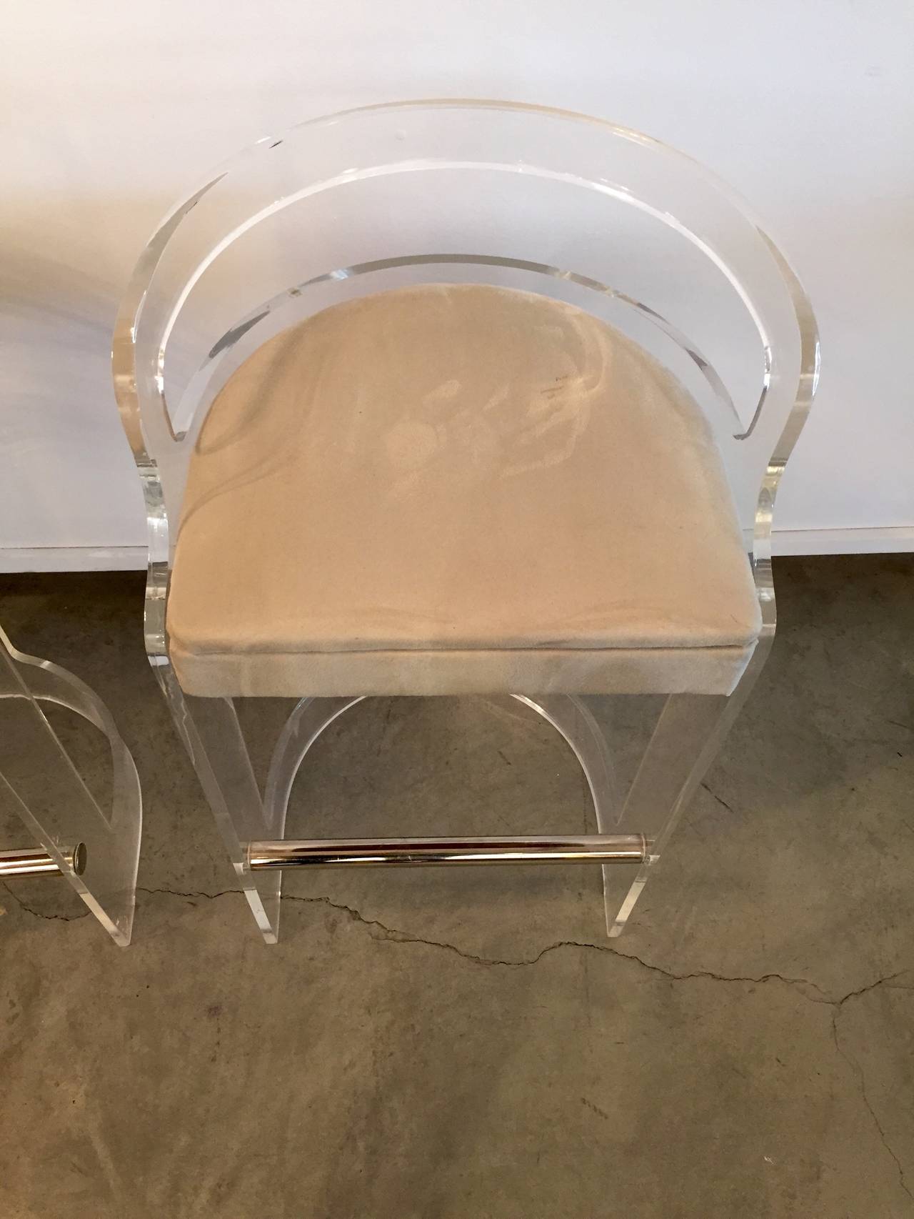 This pair of sculptural bar chairs designed by the grandfather of Lucite, Charles Hollis Jones, is a stunning example of his originality in combining metals with Lucite to produce an elegant yet very comfortable conversation piece that can fit with