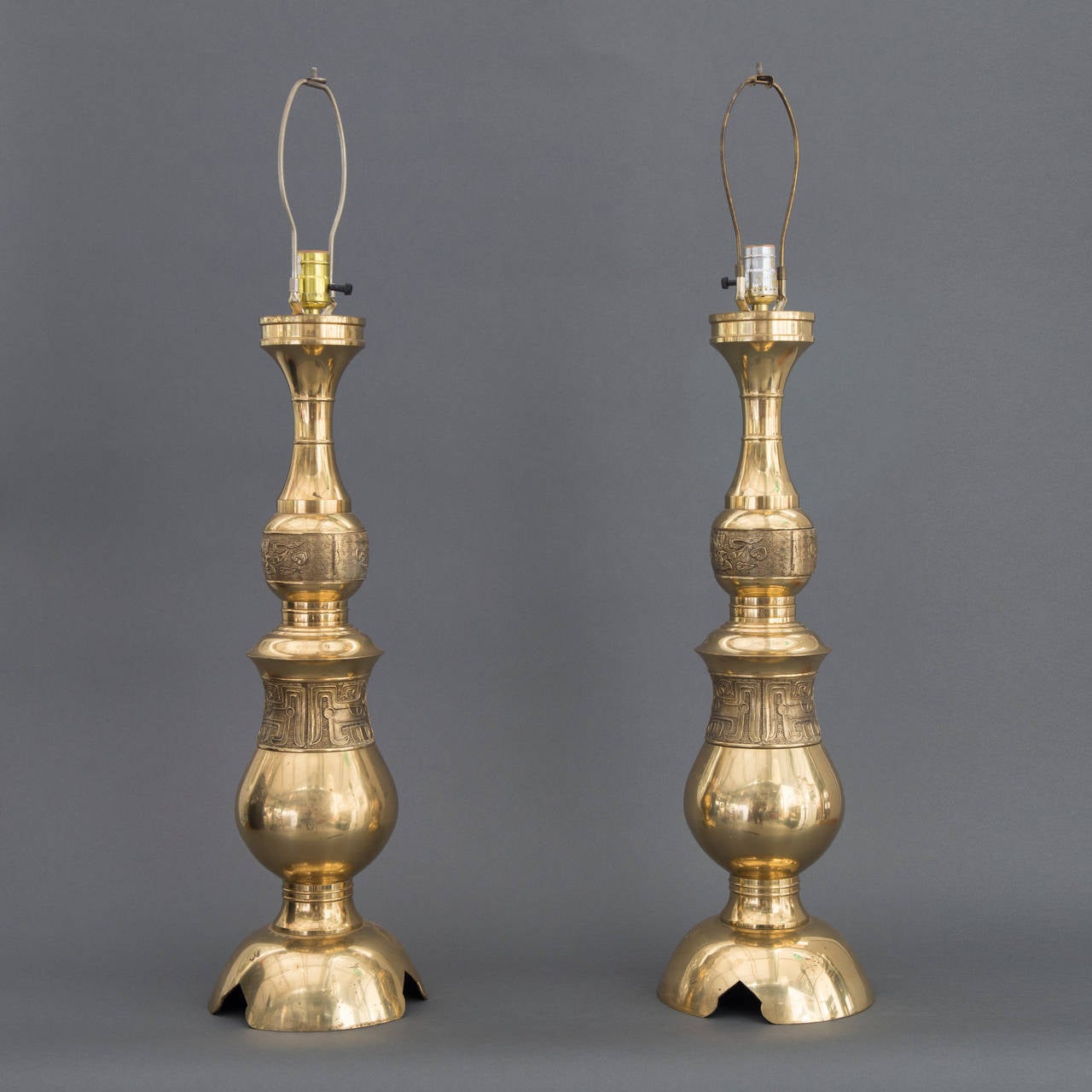Offered is a pair of Mid-Century Modern James Mont chinoiserie style engraved brass monumental table lamps. This iconic pair has probably appeared in hundreds of Hollywood movie and television sets during the mid-20th century. These 