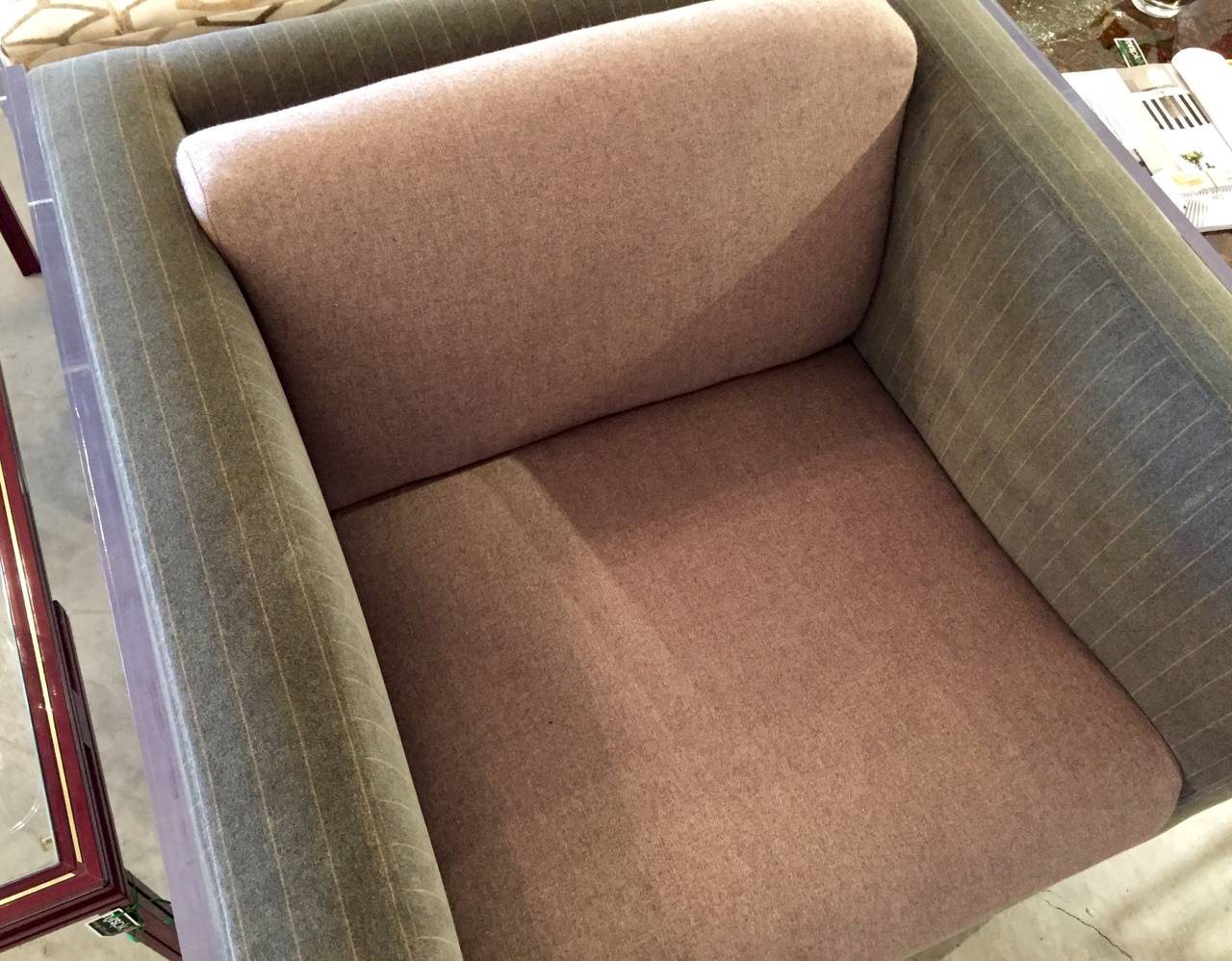 Newly upholstered, Mid-Century Modern club chair, in the manner of Edward Wormley for Dunbar, expertly tailored in a rich soft gray flannel with a milk chocolate hue pinstripe and solid cushion. A touch of mod has been added with Lucite panels. An
