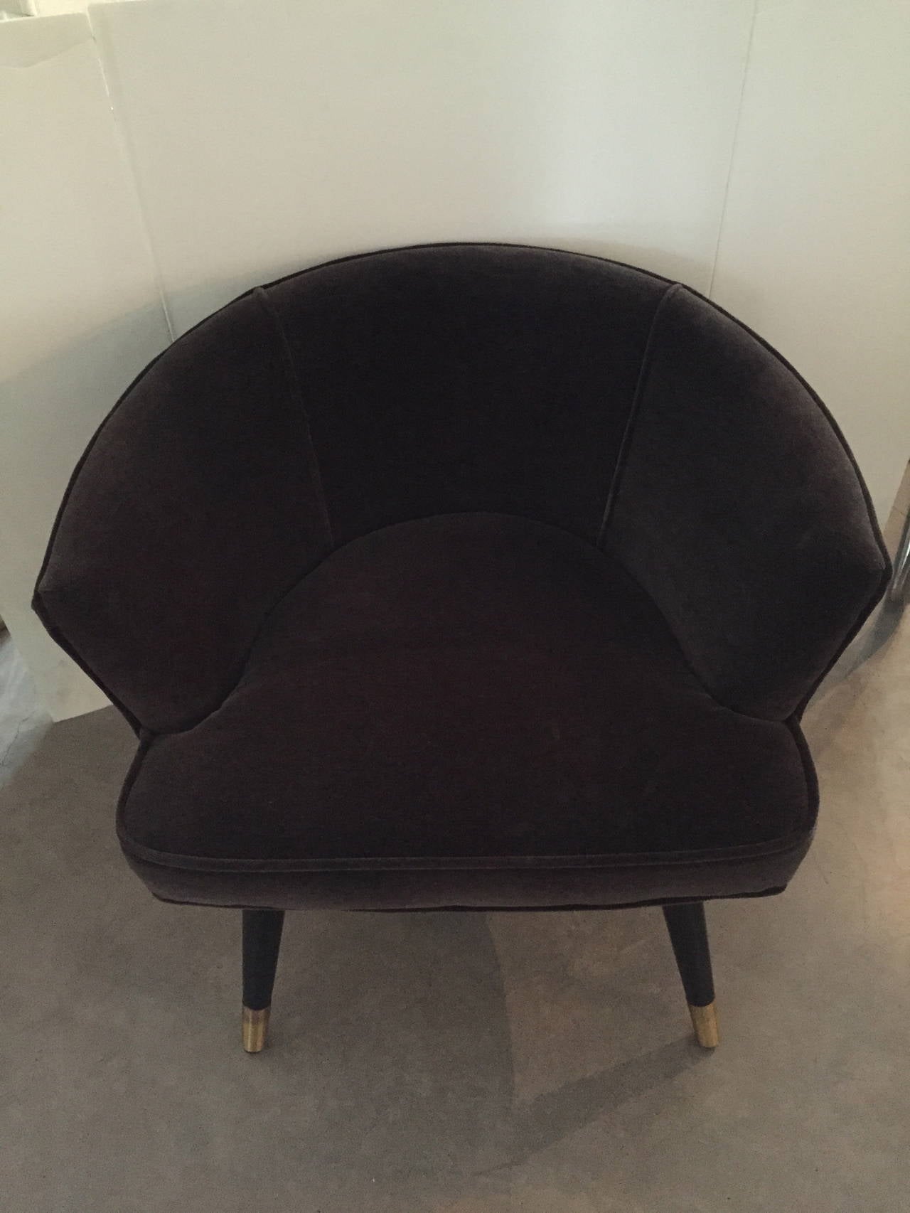 This beautiful demure Parisian armchair is newly upholstered in charcoal mohair velvet with the added chic touch of brass, accenting the wood legs. This versatile armchair could go just about anywhere in one’s home, office or shop.