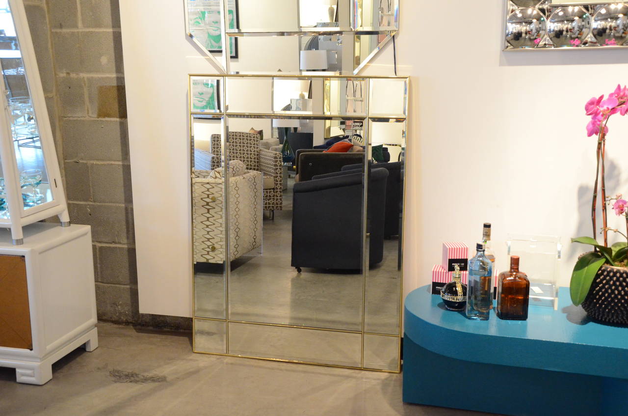 Sheer glamour radiates from this beautifully beveled decorative mirror, separated by brass into modern geometric sections reminiscent of a Mondrian painting. Meets the standard of the “must have” for 2014 in décor with its geometric design and its