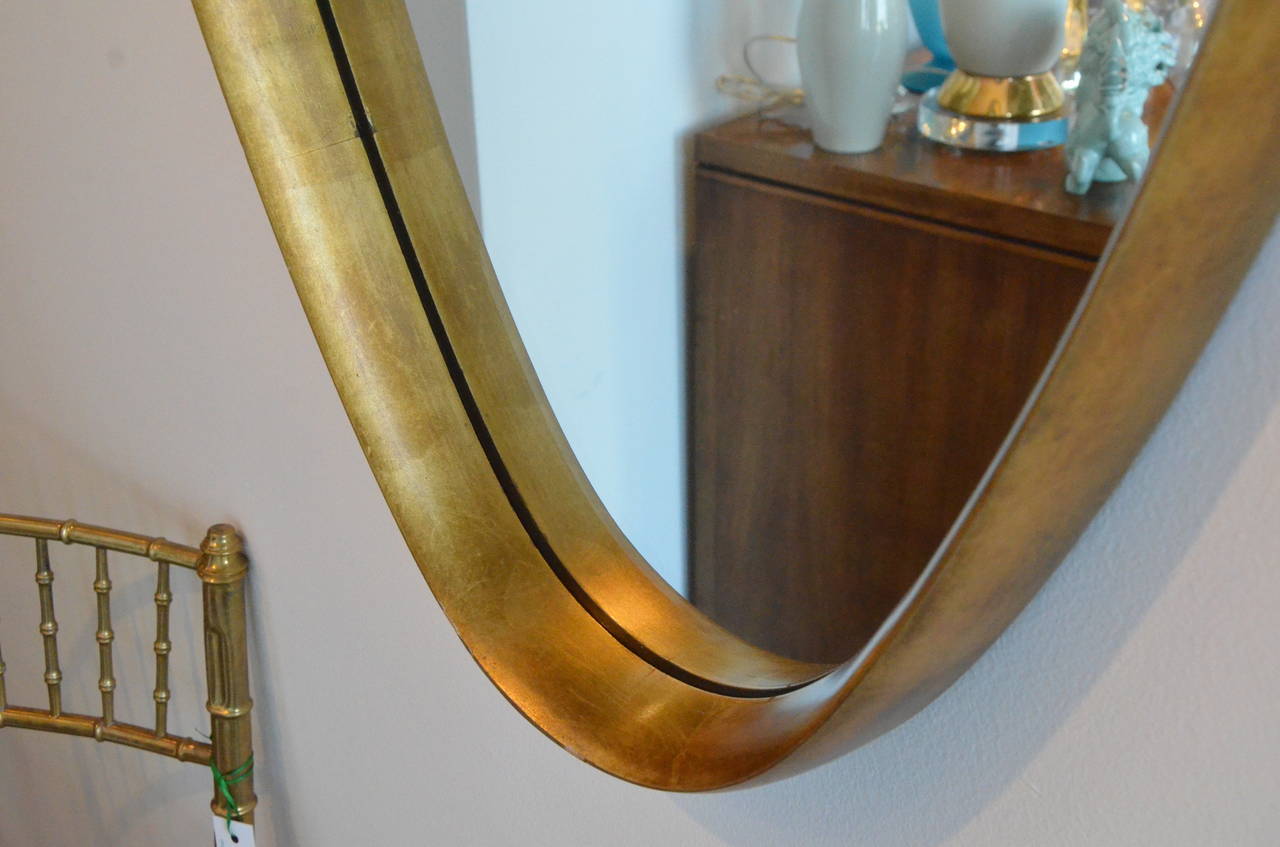 Vintage mid-century modern large oval gilded decorative mirror by Labarge. Labarge employs only the most skilled artisans, who create pieces by hand, using time-honored techniques, from sculpting and carving to hand rubbed finishes and gilding.