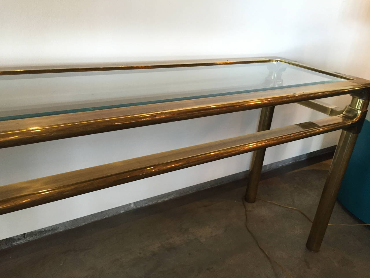 Offered is an extremely rare brass and glass console by Mastercraft. Perfect for displaying vintage cocktail sets, art glass, books…anything! Even if you can find one of these gems in pristine condition on the market, you will never see it for this
