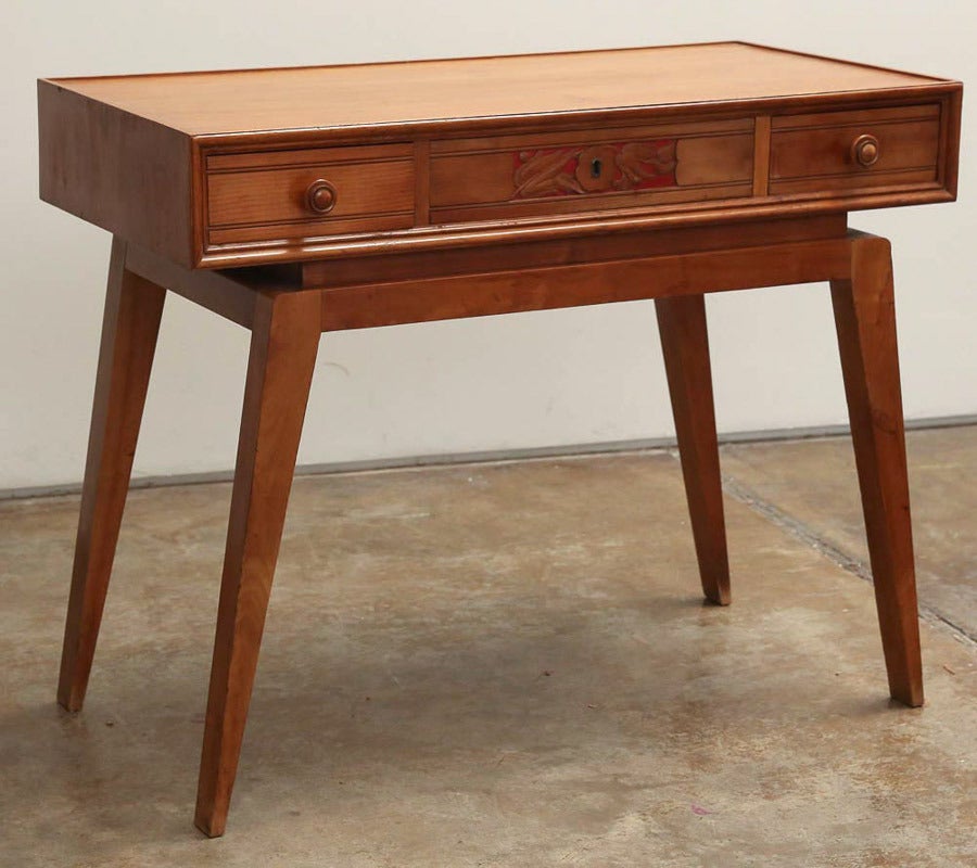 Offered is a true example of Italian Mid-Century Modern maplewood writing desk, melding both "old world" charm with Classic, clean modern lines. This piece is finished on all sides and would look fabulous in basically any part of any room