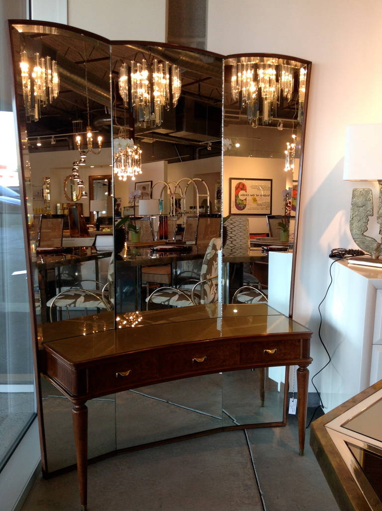 Vintage MCM triple floor length mirror console or dressing table has a reverse gilt painted tabletop and unique brass pulls for its three slim drawers. This is such a truly unique piece, representative of the Mid-Century Italian artistry in design