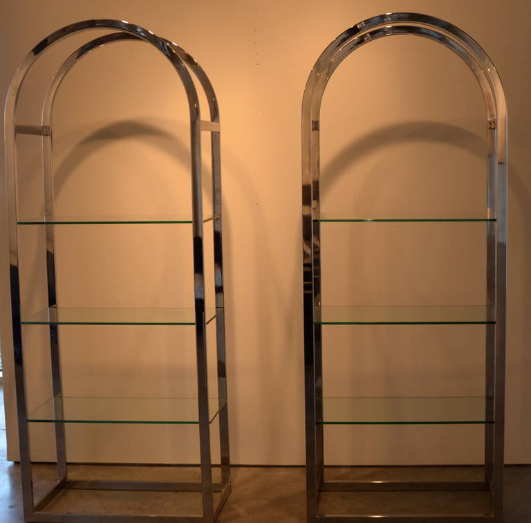 Very rare, vintage, signed, chrome and glass etageres by the 20th century icon, Pierre Cardin. The chrome has been polished to bring this pair back to their original luster, highlighting the iconic Cardin arches. This elegant pair of etageres would