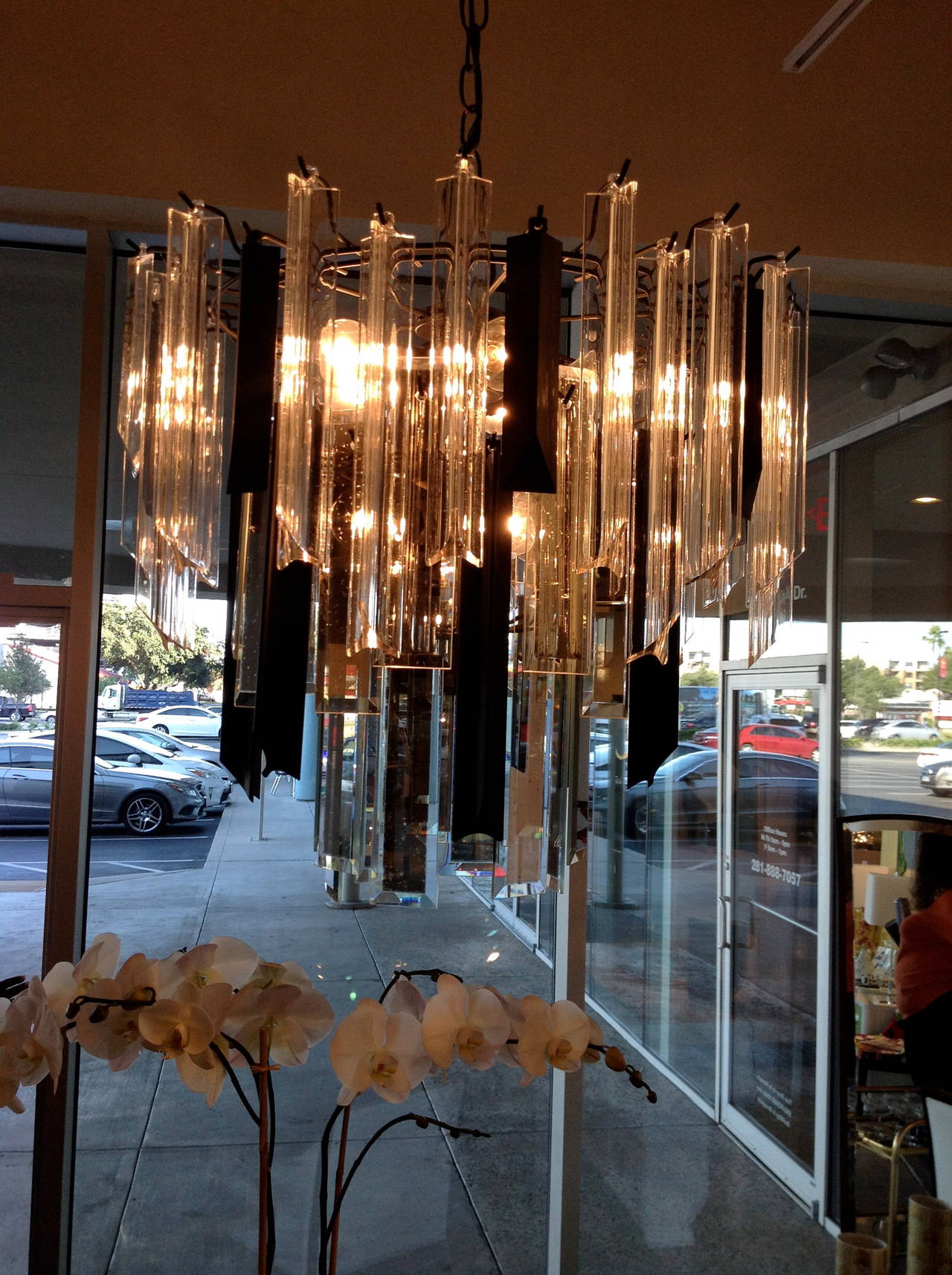 This chandelier is quite unique and is a stunner in its diverse clarity, with its opaque, clear and mirrored prisms.  It can be quite dramatic in any setting or just simple, clean and bold.  This piece would look perfect in any area of a home. 