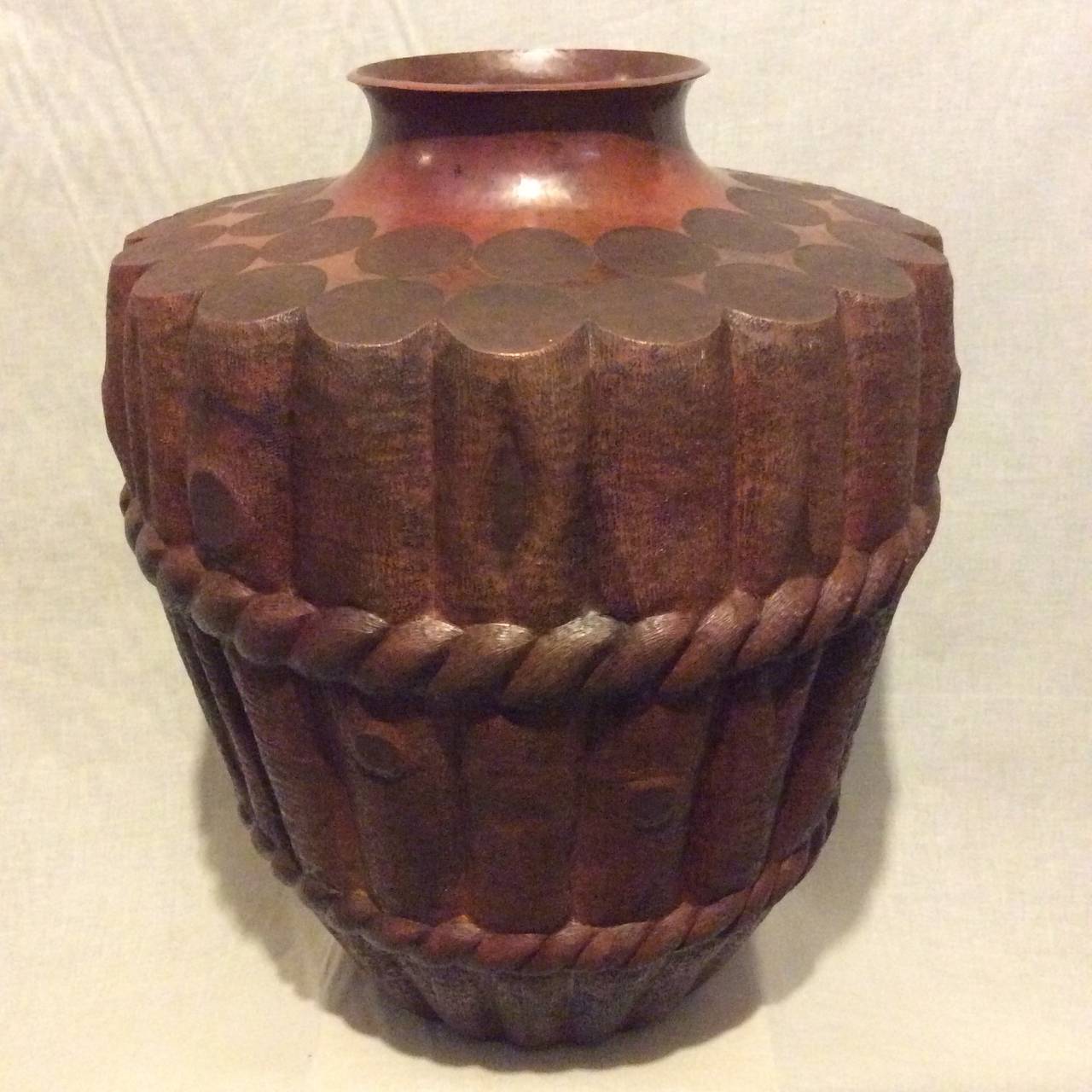 One of a kind!
Copper repousse master work.
This impressively large copper vase brings to life the essence of rustic stylized wood branches bound with undulating rope. It references both Asian and American themes.