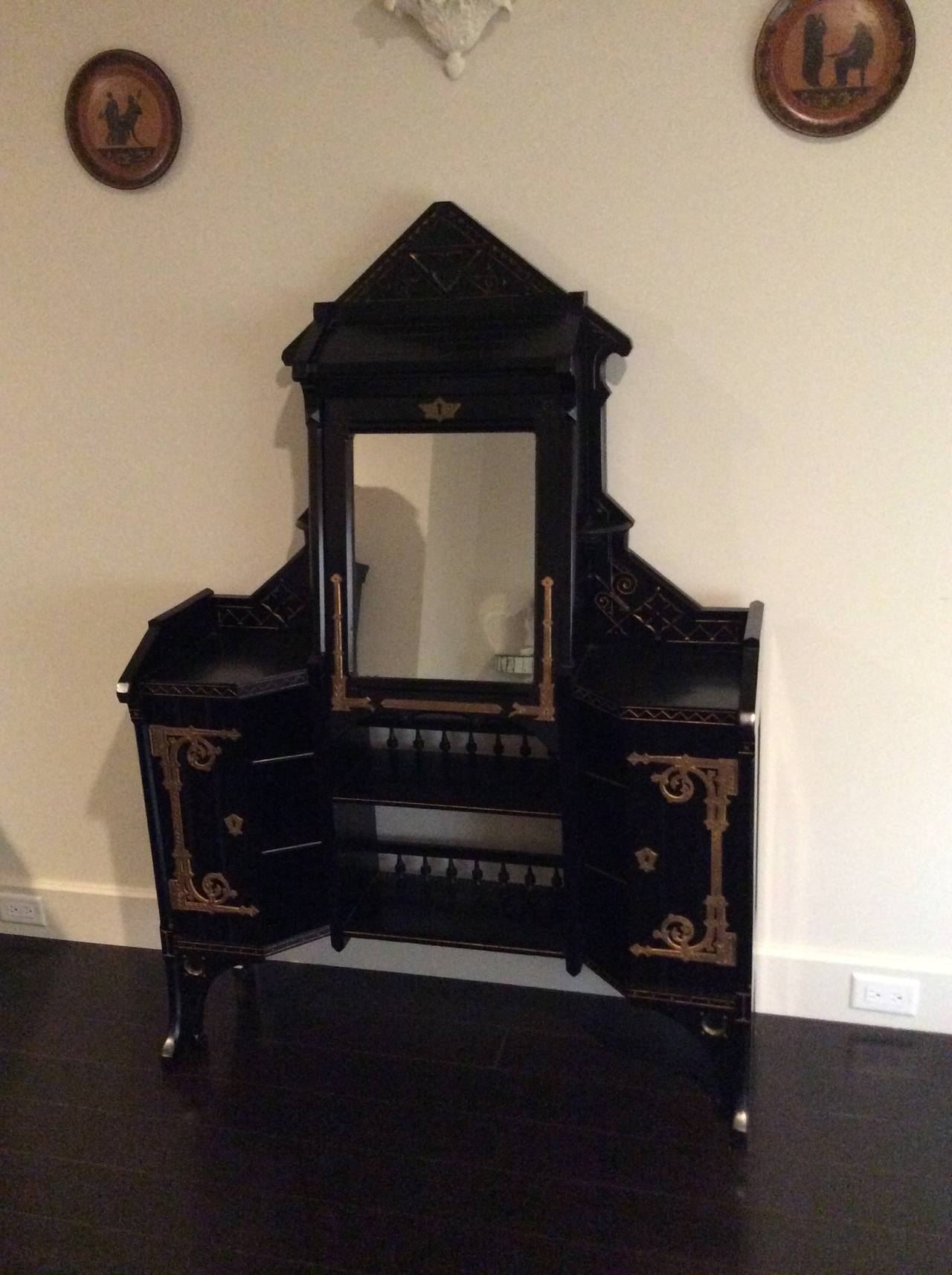 Kimbel and Cabus Aesthetic Movement or modern Gothic ebonized cherry drop front desk. Gilt incised geometric design highlighted by 'modern Gothic' strap hardware on door panels. Mirror front.