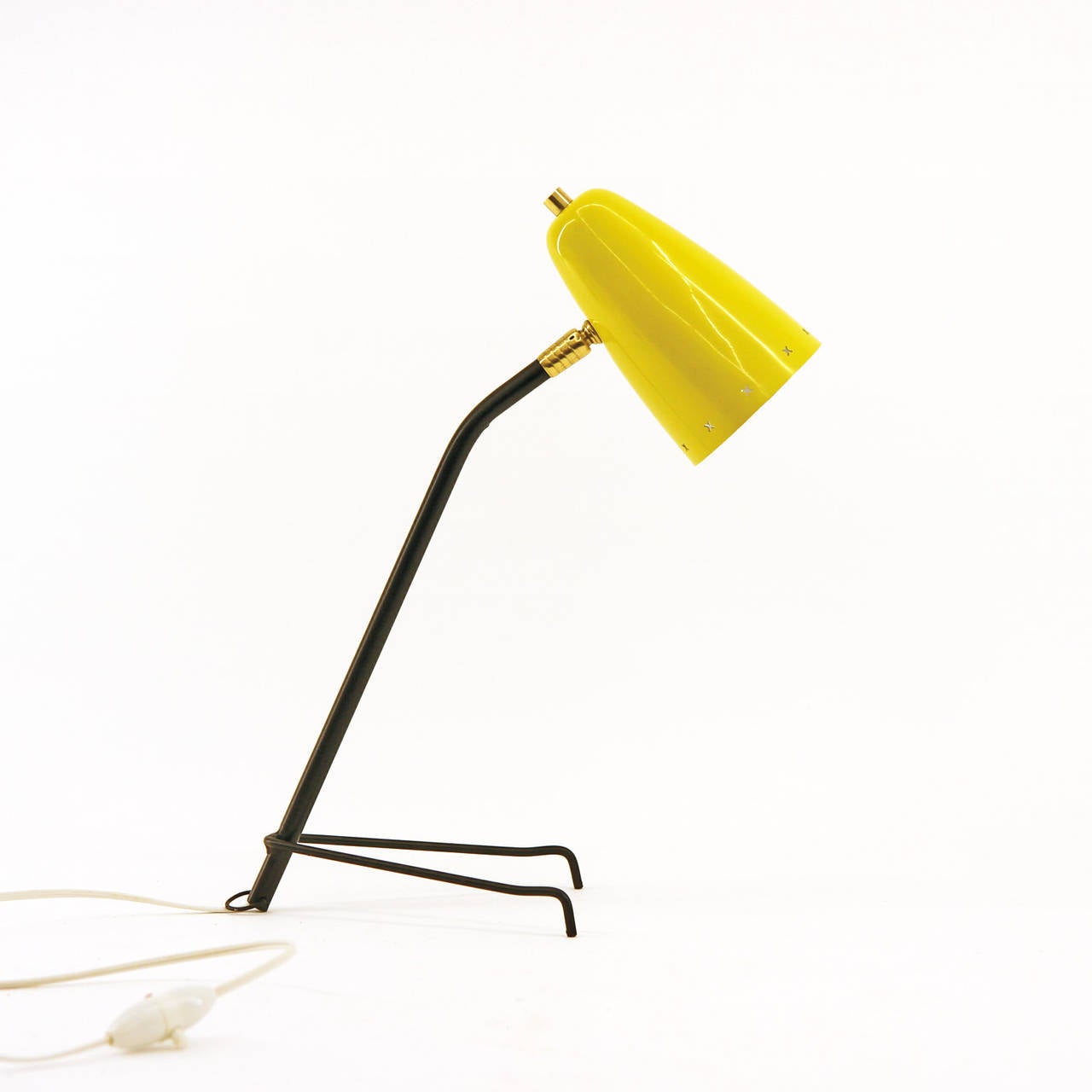 Modernist French table lamp from the 1950s with bright yellow lacquered aluminum shade with X-shaped perforations. Excellent original condition with minor wear to the inside of the shade. Can also be hung on the wall.