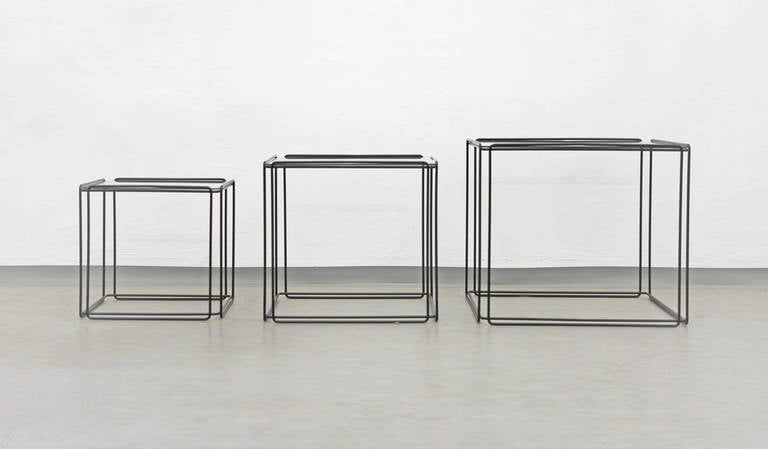 A striking set of minimalistic nesting tables by French artist Max Sauze. Very sculptural, yet unobtrusive presence. Black enameled steel wire frame with glass tops.
