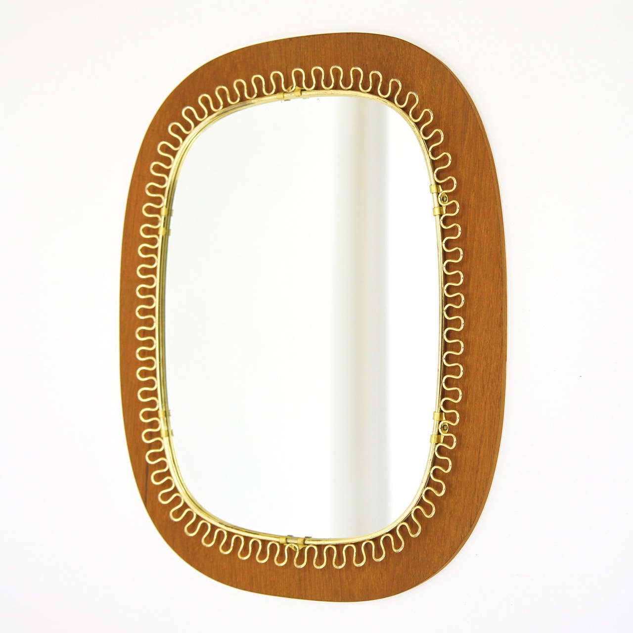 Rare version of Josef Frank's loop mirror with a teak backplate. Excellent condition with a nice patina on the brass.