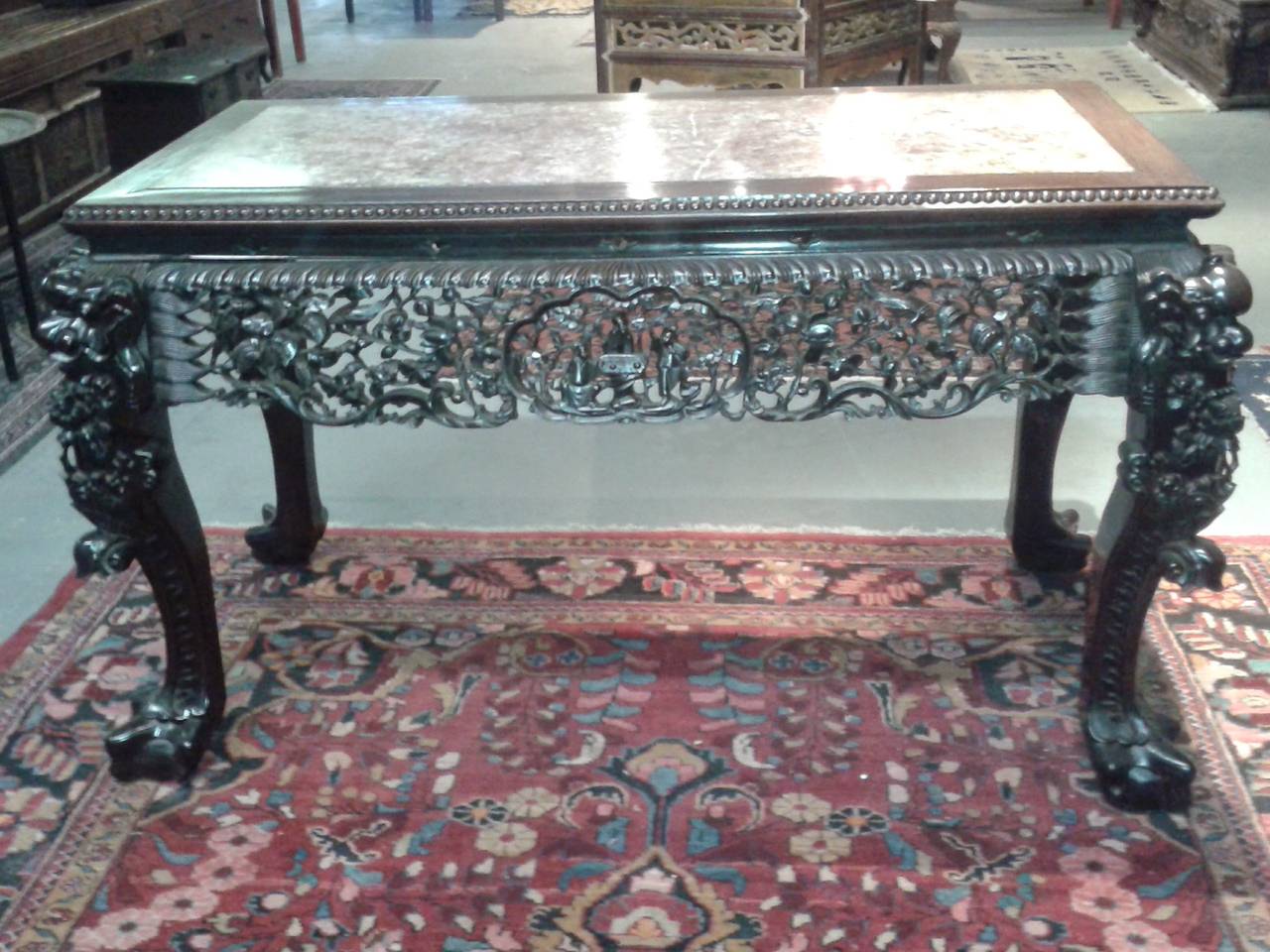 Antique Chinese carved rosewood and marble desk. Wonderful antique piece that is dated to be over 200 years old. Substantial and uniquely striking mauve marble and great detail.