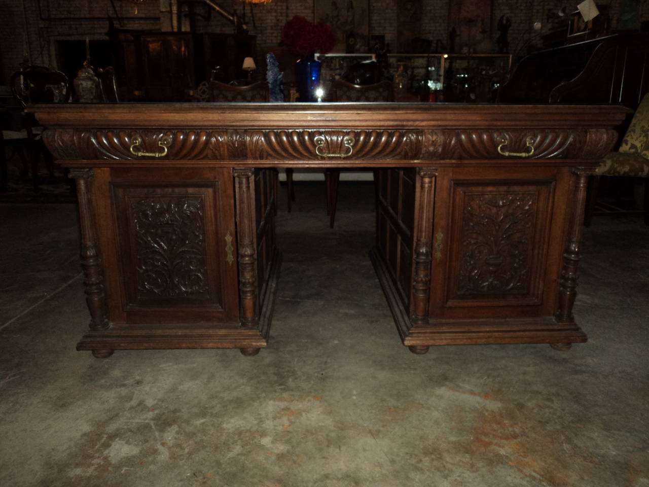 Carved Walnut Parquet Top Partners Desk makes a stately impression.  It's doors are finely carved urns.