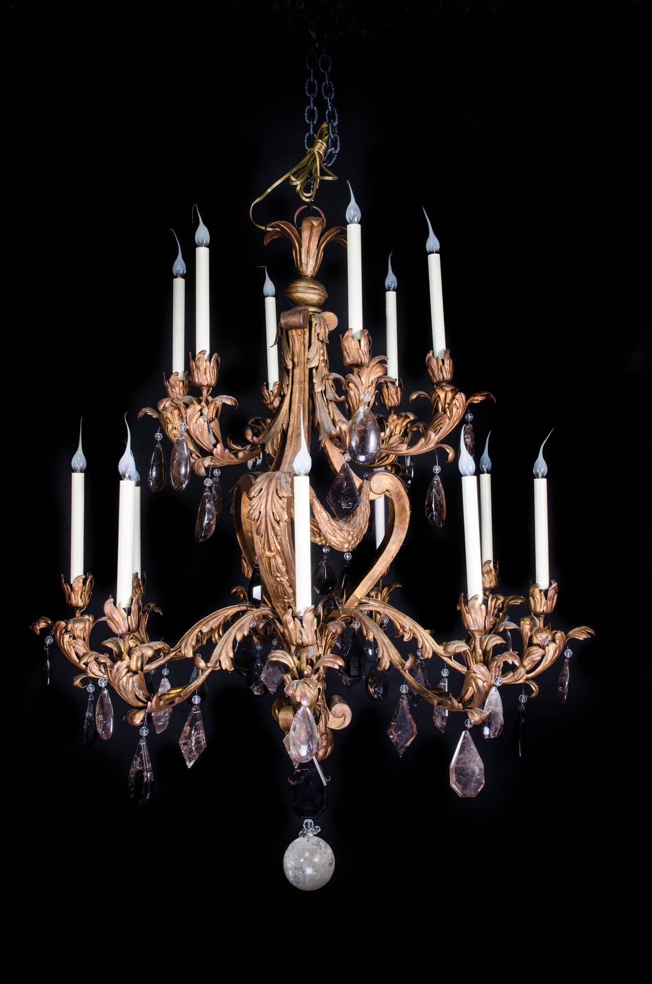 A large antique French Louis XVI style gilt tole, cut smokey rock crystal and cut rock crystal multi light double tier chandelier embellished with large smokey cut rock crystal prisms & finally adorned with a cut rock crystal ball.