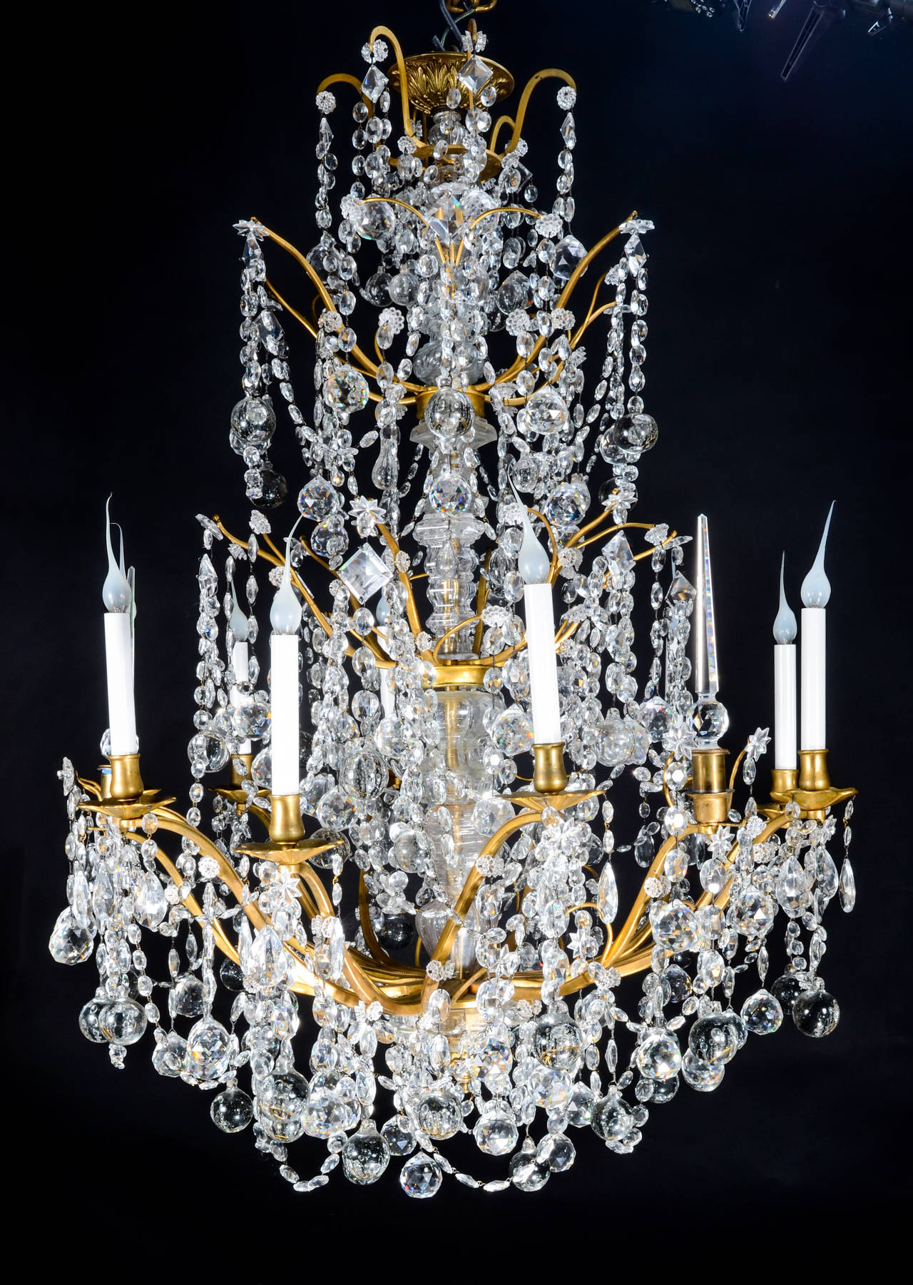 A Large and Unique Antique French Louis XVI Style Gilt Bronze and Cut Crystal triple tier multi light chandelier embellished with round ball form cut crystal prisms and cut crystal chains att. to Baccarat, Paris