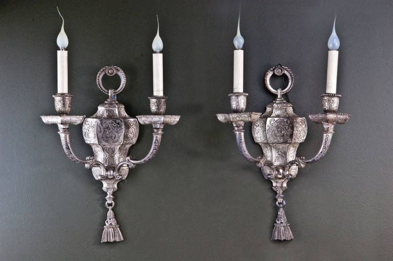 A pair of unusual antique American silvered bronze Caldwell Moorish style double light wall sconces.