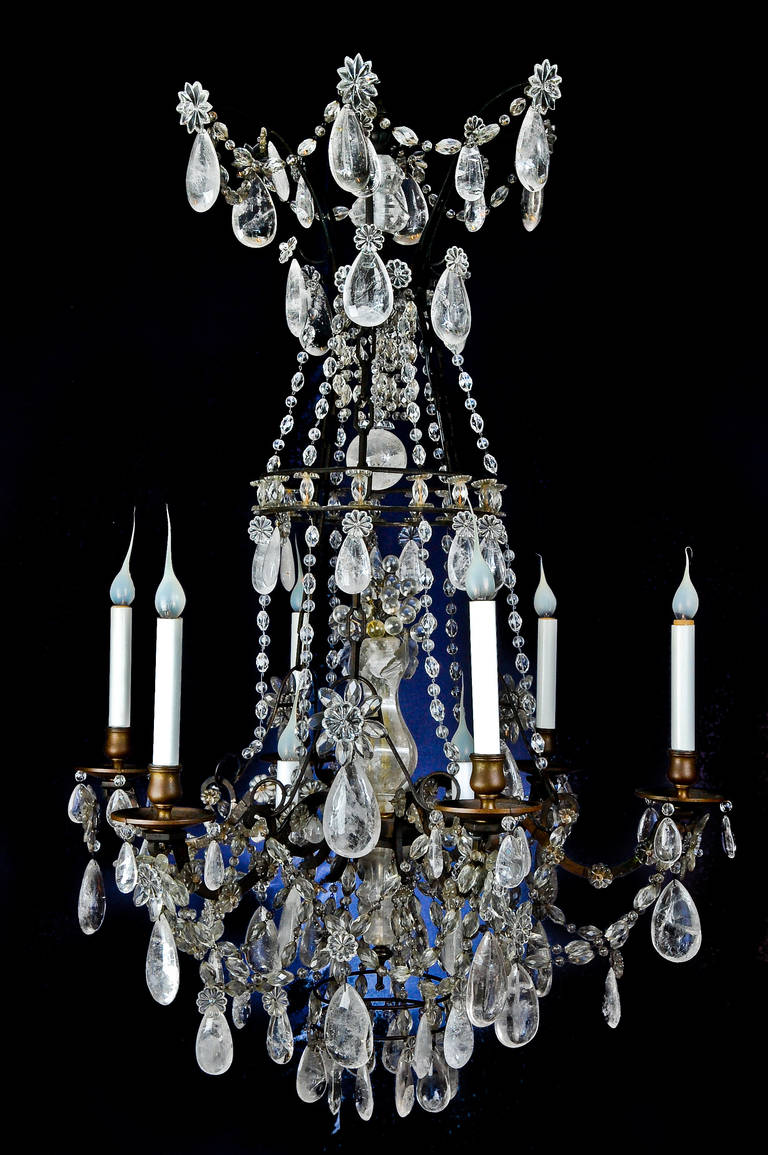 A fine antique French Louis XVI style patinated bronze, cut rock crystal and crystal multi light chandelier.