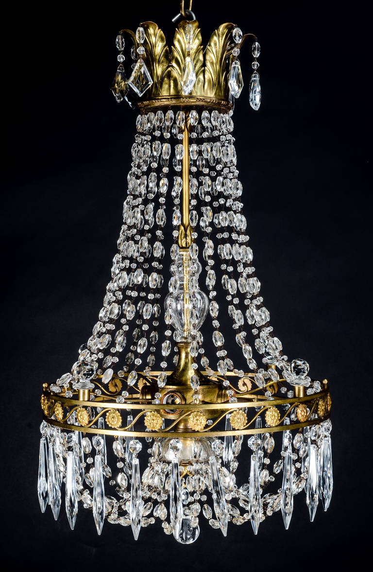 An antique French Louis XVI style gilt bronze and crystal chandelier.