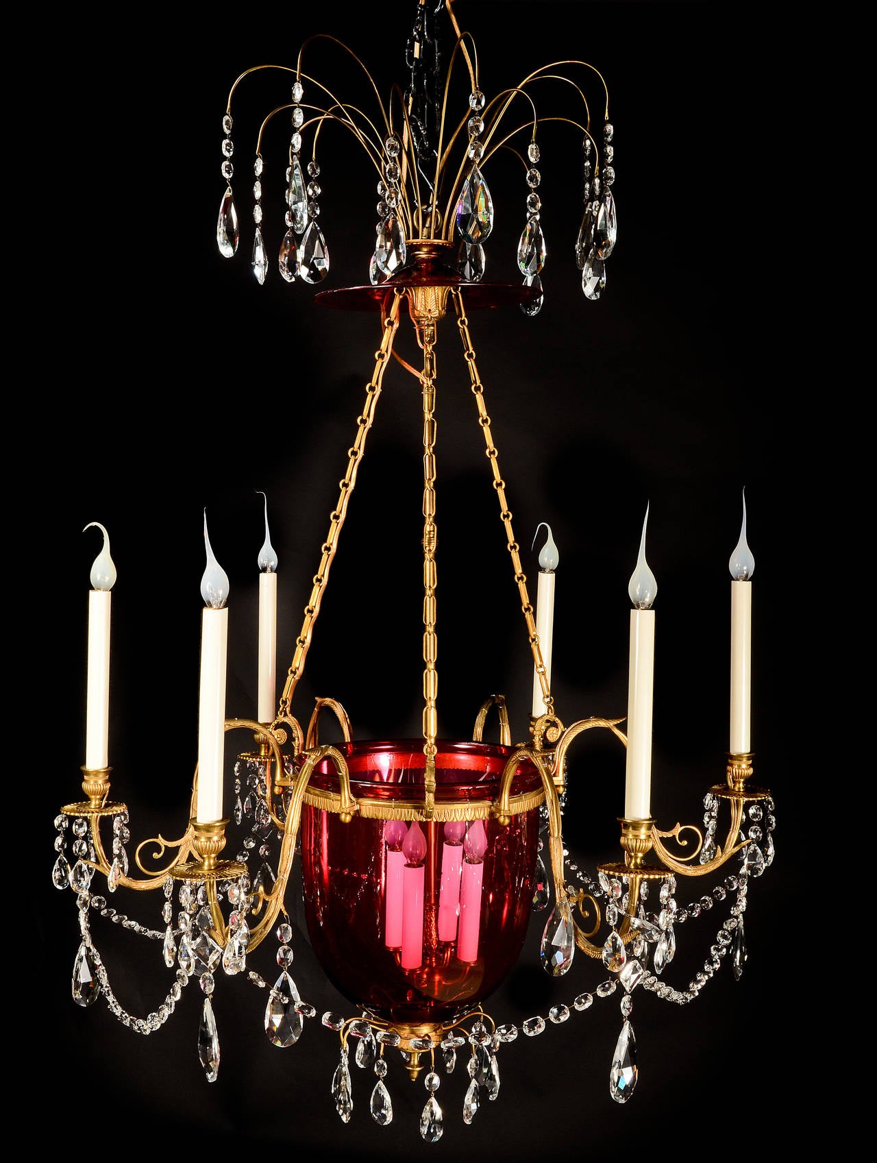 A fine antique Russian neoclassical gilt bronze, cut crystal and cranberry glass multi light lantern chandelier embellished with gilt bronze arms, central cranberry glass, cut crystal chains and prisms.