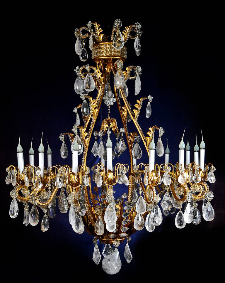 A monumental and large Bagues style gilt metal and cut rock crystal multi-light chandelier.