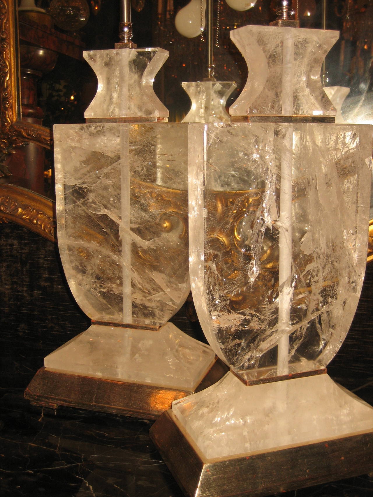 A pair of Art Deco style cut rock crystal silvered mounted lamps.