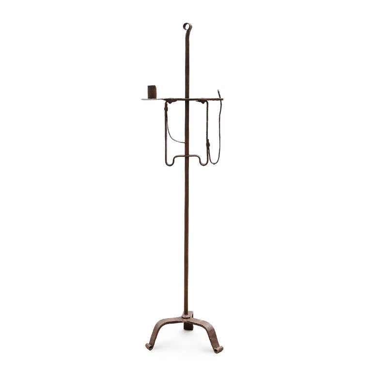 18th century Swedish floor standing wrought iron rush light with candle holder. Fully adjustable with two options for the light source, a candle holder on one side and a rush nip holder on the other.