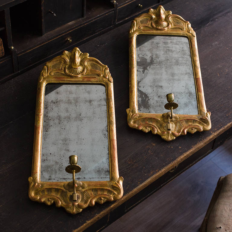 Fine pair of period Swedish Rococo mirror sconces in original gilt and glass, circa 1770.